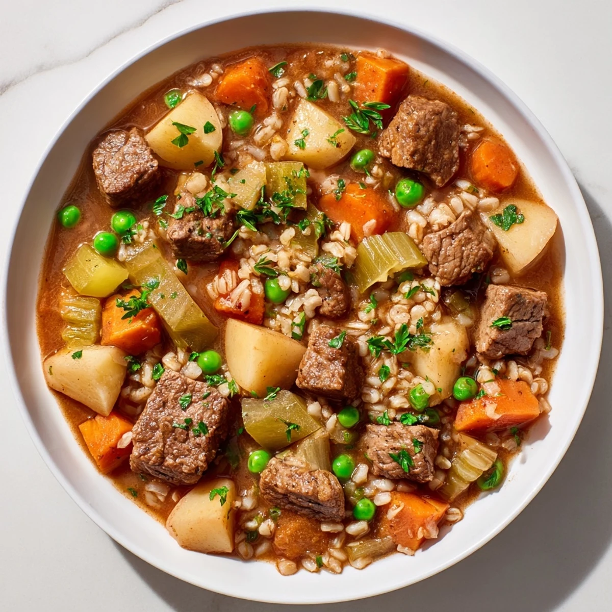 Steaming bowl of One-Pot Hearty Beef and Barley Soup with tender beef and vegetables, ready to serve.