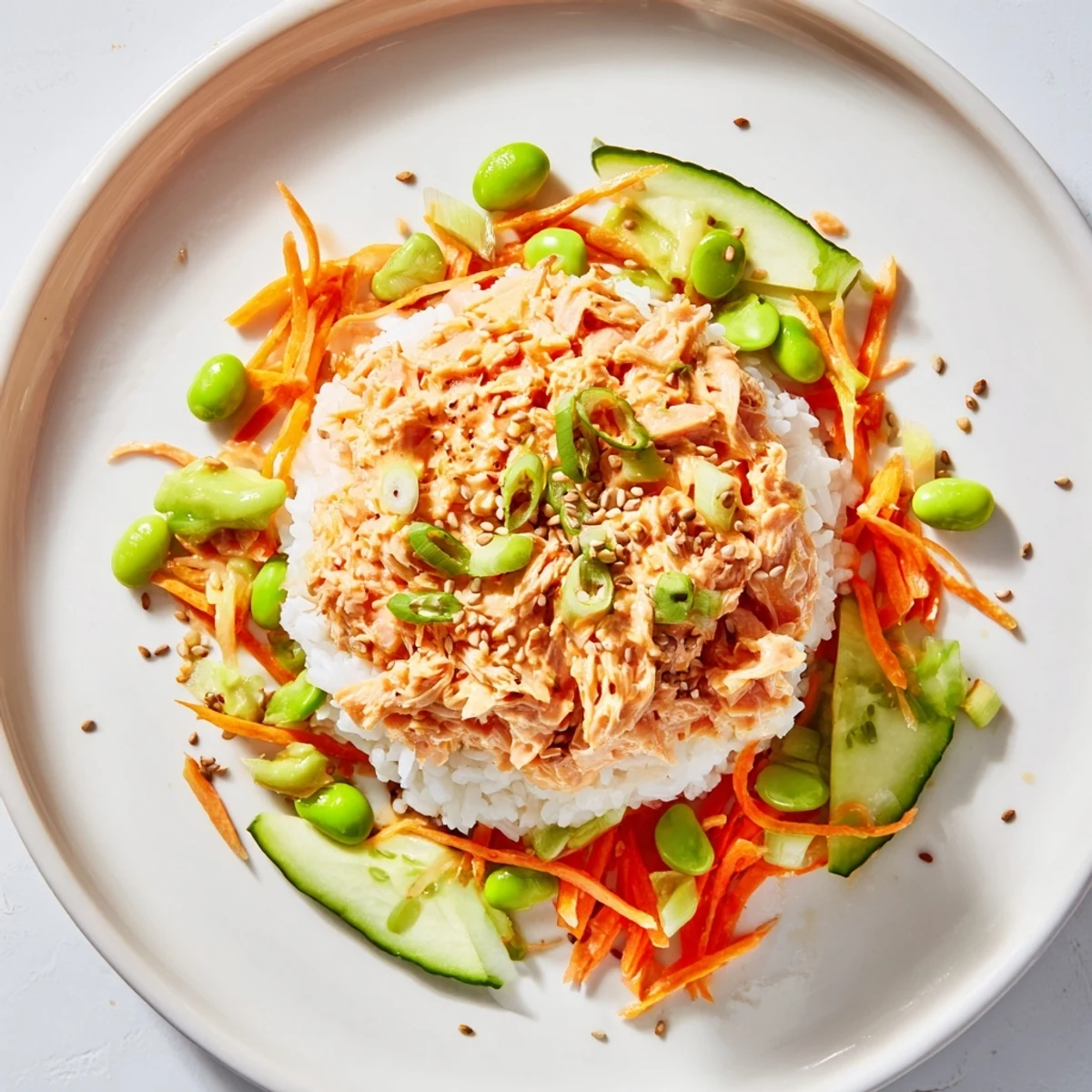 This vibrant Spicy Canned Salmon Rice Bowl features creamy salmon, crunchy veggies, and a spicy kick.