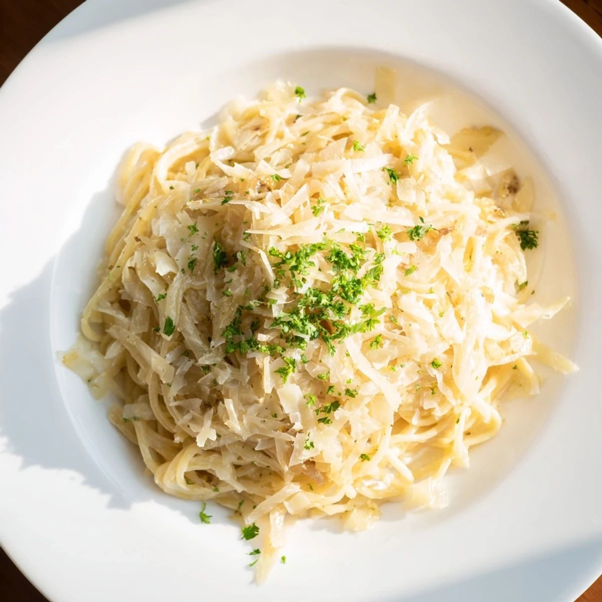 A close-up of a steaming bowl of One-Pot French Onion Pasta, fragrant and delicious with bubbling cheese.
