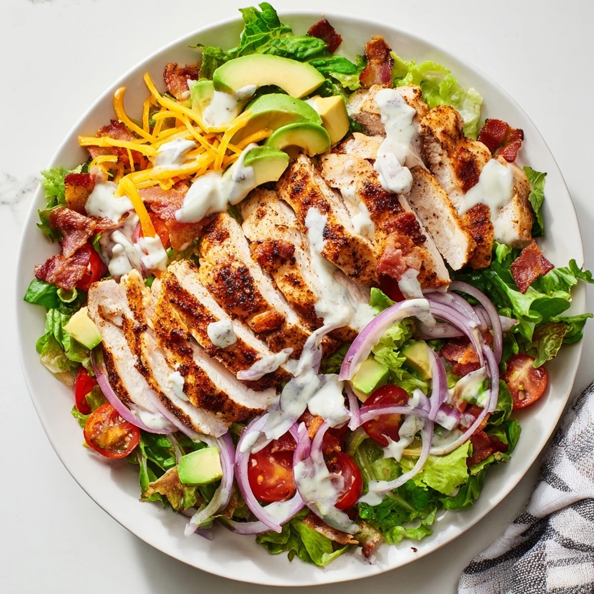 Golden, crispy bacon chicken salad served over fresh greens, drizzled with creamy ranch dressing.