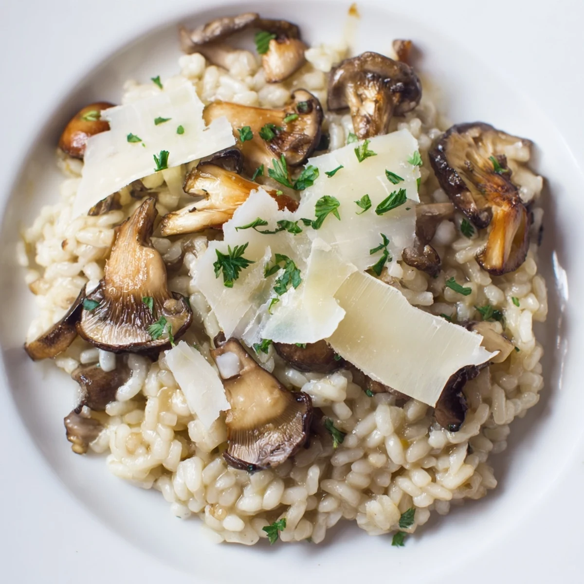 A steaming bowl of Italian Mushroom Risotto, garnished with fresh parsley and Parmesan.