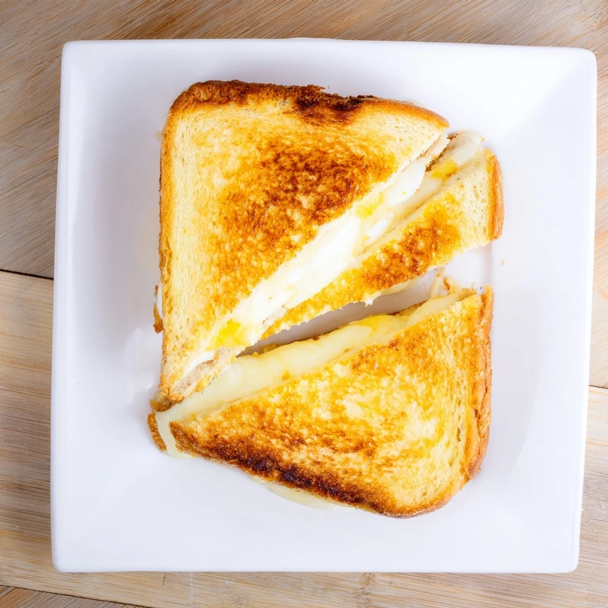 Golden, crispy slices of thick sourdough bread hold a rich melt of cheddar, provolone, and mozzarella in this Triple Cheese Sourdough Grilled Cheese.  