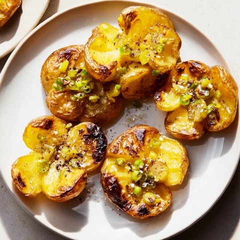 Golden and crispy smashed green onion potato bombs, a flavorful vegetarian side dish with scallion oil.
