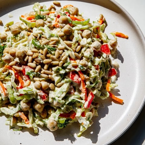 Vibrant Fiber-Forward Chickpea Salad showcasing colorful vegetables, tossed in creamy tahini-lemon dressing.