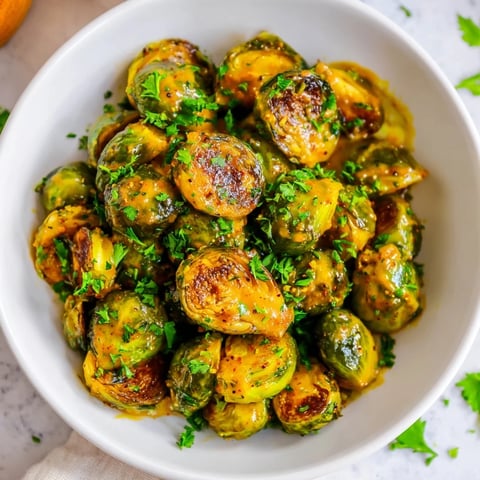 Golden, caramelized Honey Mustard Glazed Brussels Sprouts sit ready, a perfect side dish, glistening.