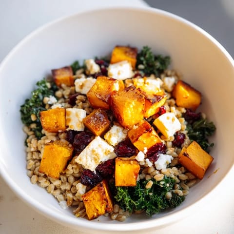 Warm, inviting image: a Harvest Grain Bowl features roasted pumpkin with a medley of grains and greens.