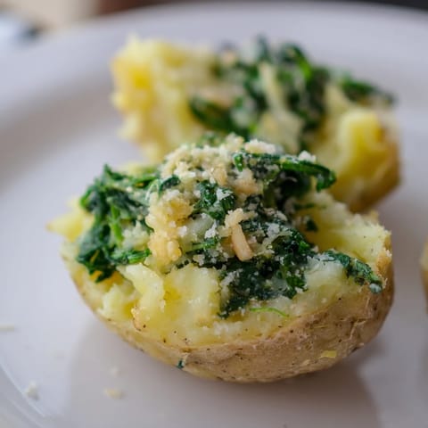 A close-up of creamy spinach and Parmesan mashed potatoes, ready to be served and enjoyed warm.