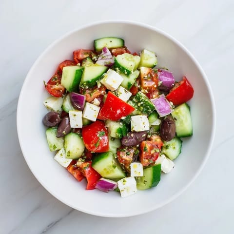 Bright, flavorful photo of Fresh Mediterranean Salad featuring olives, crisp veggies, and a tangy dressing.