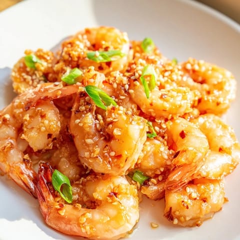 Succulent, saucy Honey Garlic Shrimp with vibrant green onions, a quick and easy weeknight meal.