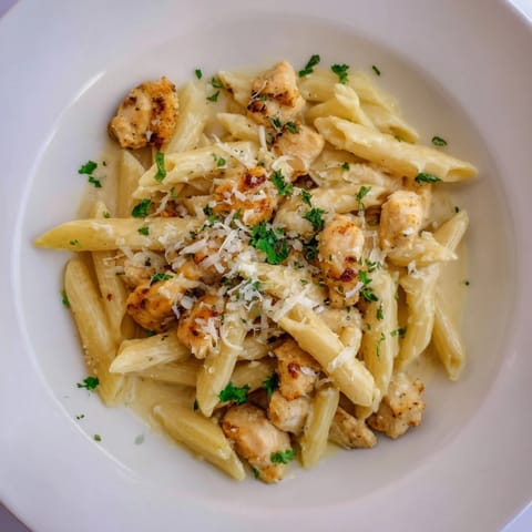 A close-up of quick Garlic Parmesan Chicken Pasta, showing golden chicken and perfectly cooked pasta.