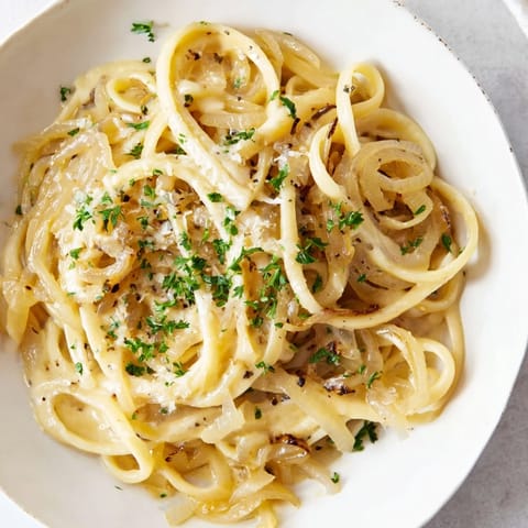 This warm One-Pot French Onion Pasta has bubbly, melted cheese on top of perfectly cooked pasta.