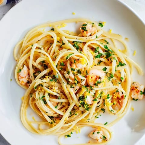 Plate of Lemon Garlic Shrimp & Chicken Pasta featuring tender shrimp and chicken tossed in a zesty butter sauce.  
