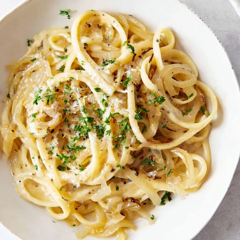 This warm One-Pot French Onion Pasta has bubbly, melted cheese on top of perfectly cooked pasta.