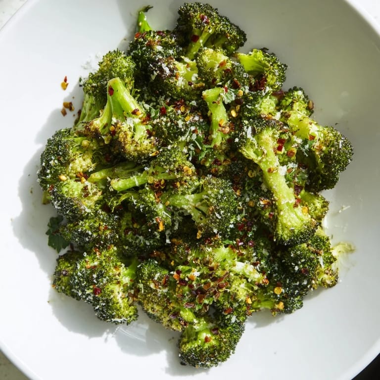 A flavorful close-up of Garlic Parmesan Roasted Broccoli, showcasing the tender florets and golden cheese.