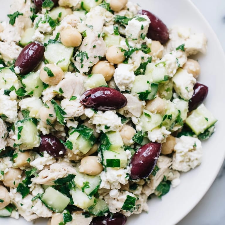 Bright Mediterranean Chickpea Chicken Salad with chickpeas, olives, and parsley served in a white bowl for a refreshing lunch.