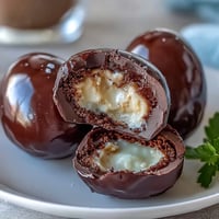 Homemade peanut butter Easter eggs with creamy filling, coated in smooth milk chocolate and decorated with colorful sprinkles.