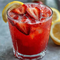 Vibrant Juneteenth Red Drink: Hibiscus Strawberry Lemonade, bursting with fruity, tart flavors.